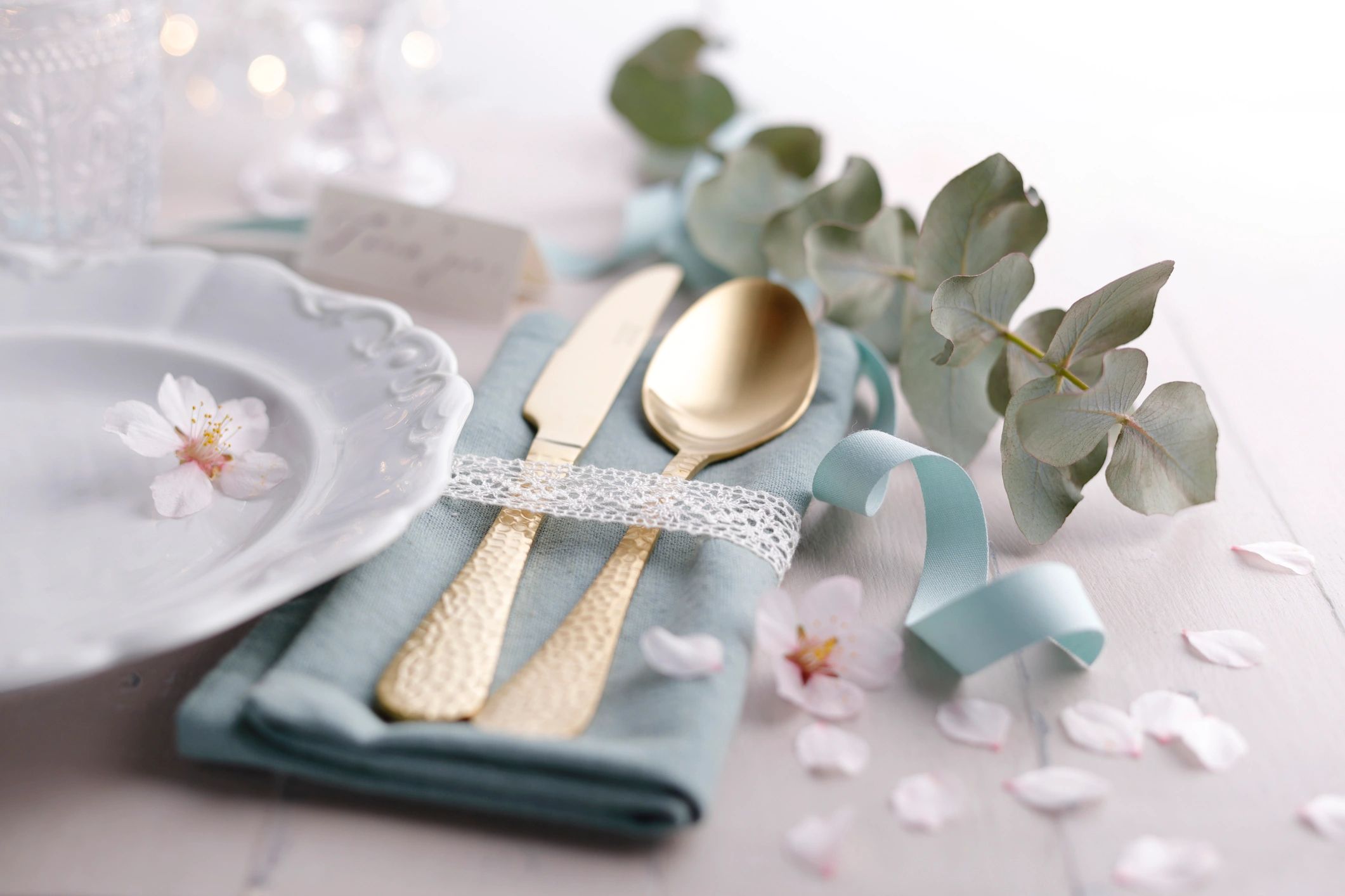 Romantic wedding table with gold accents and greenery