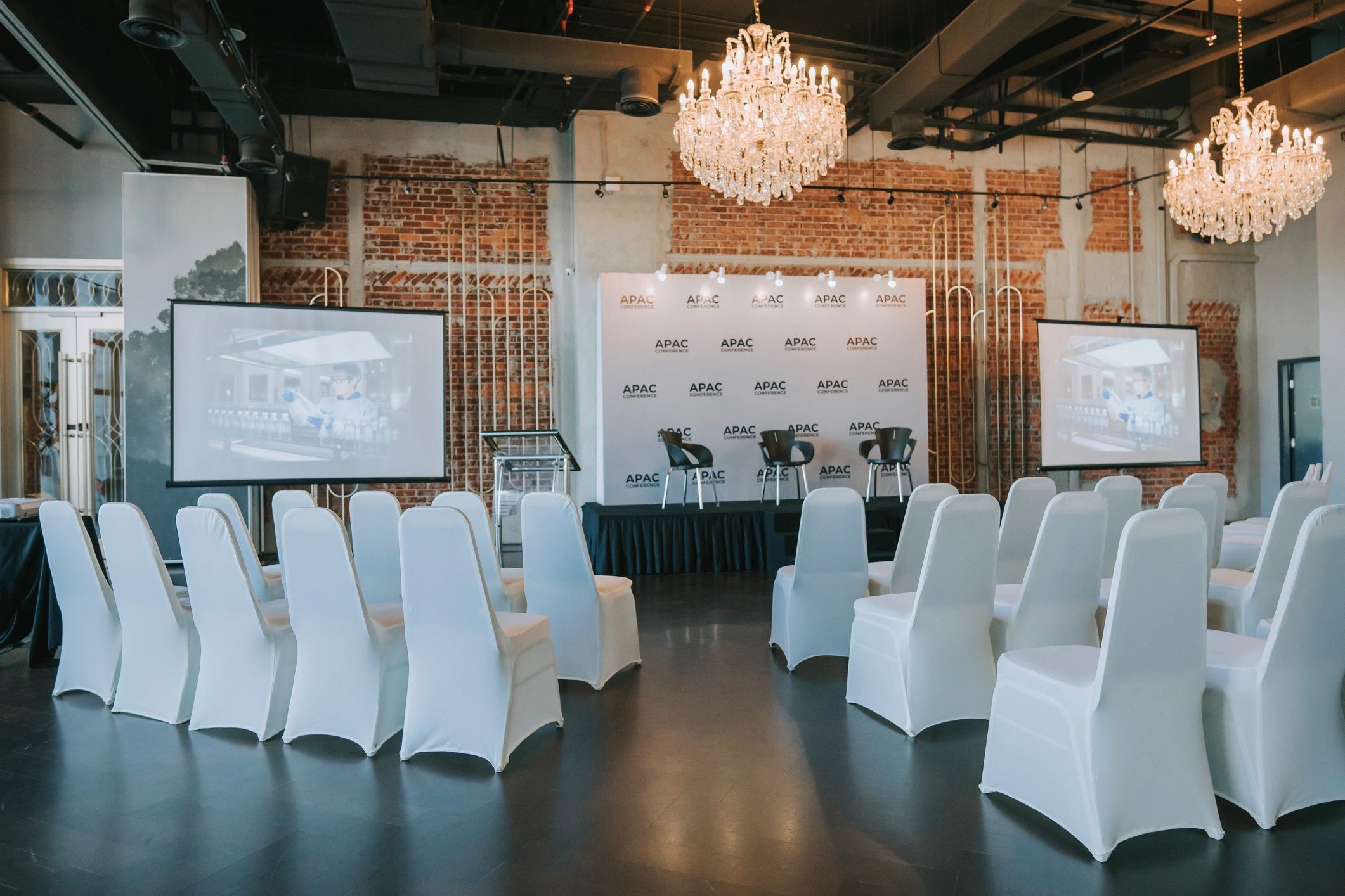 Elegant event space with stage lighting and seating