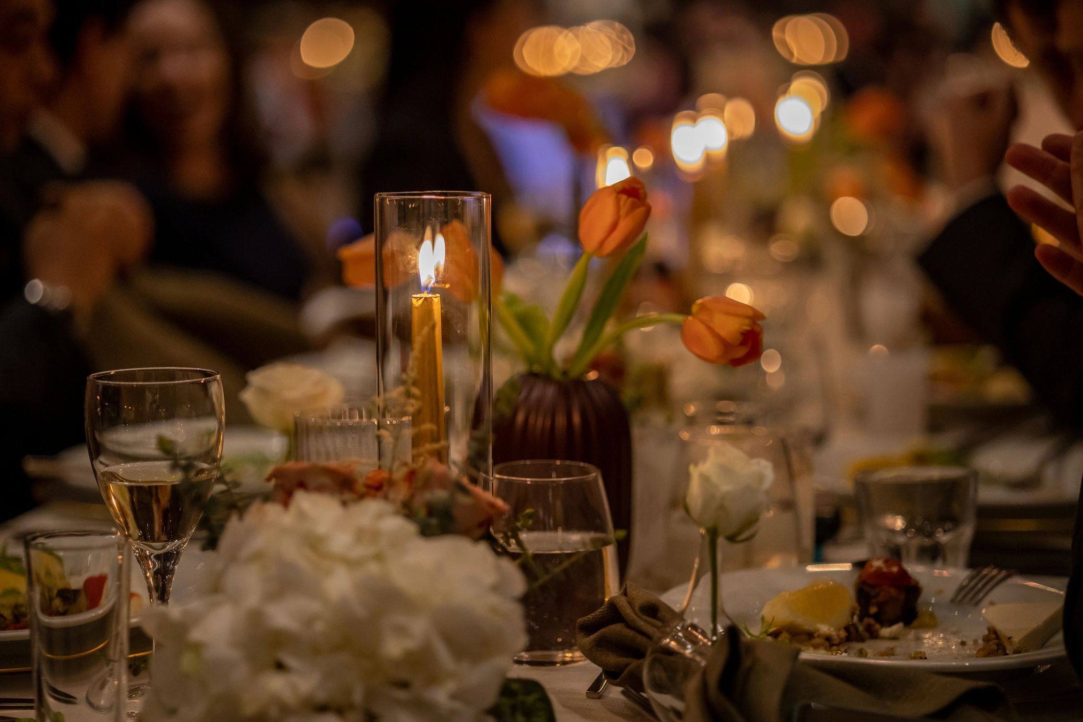 Luxury dinner table setting with layered plates and glassware