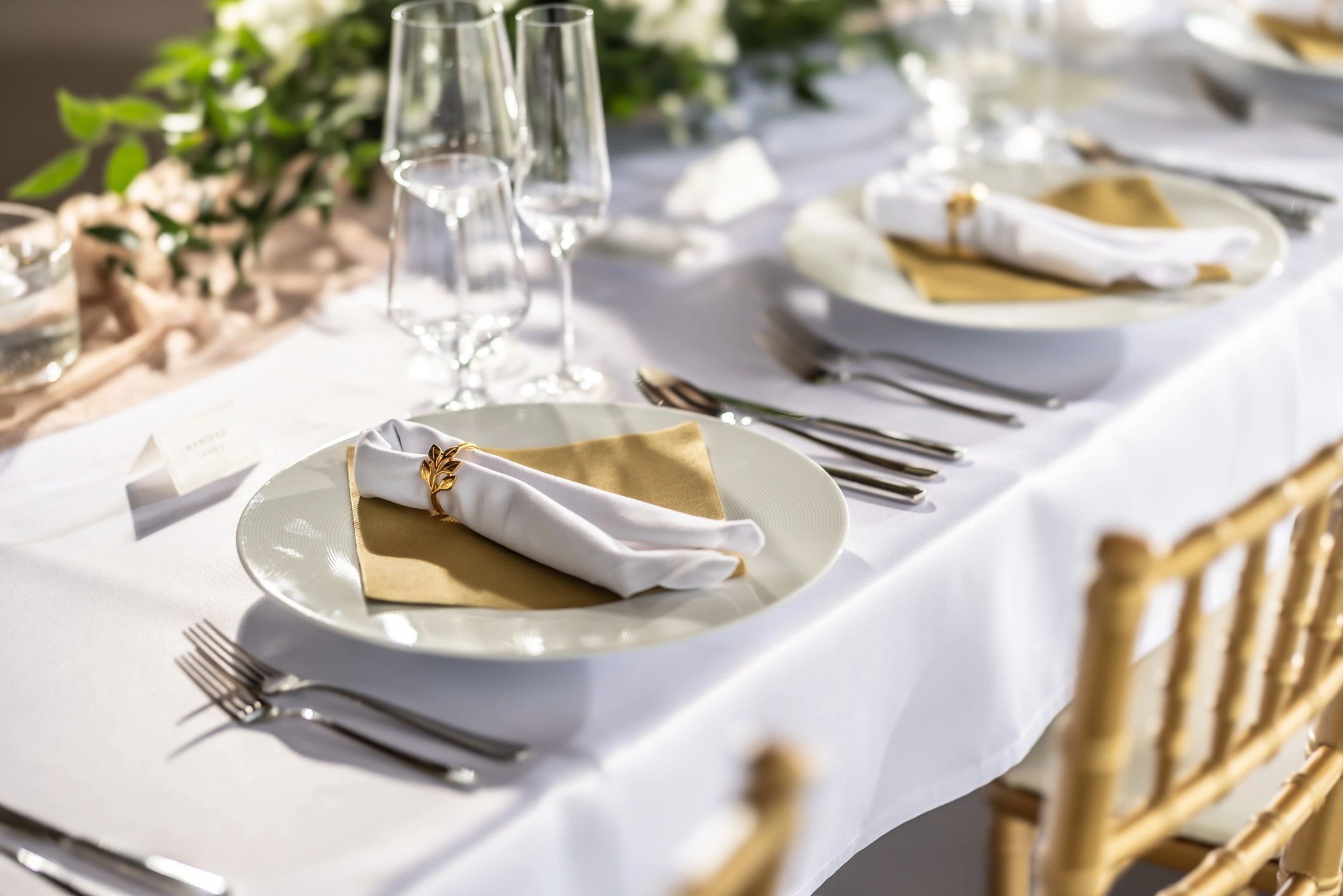 Candlelit table with flowers, glassware, and cutlery