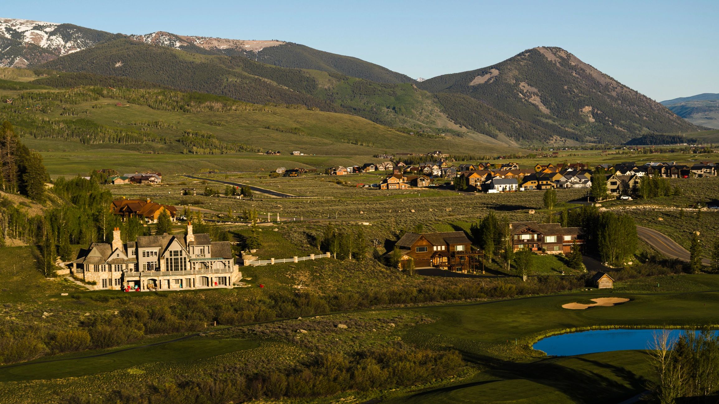 Luxury estate homes at dusk with mountain backdrop