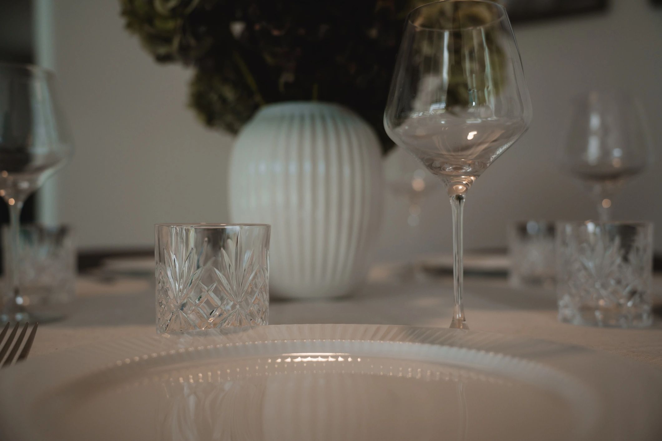 Formal place setting with crystal glassware and white plate