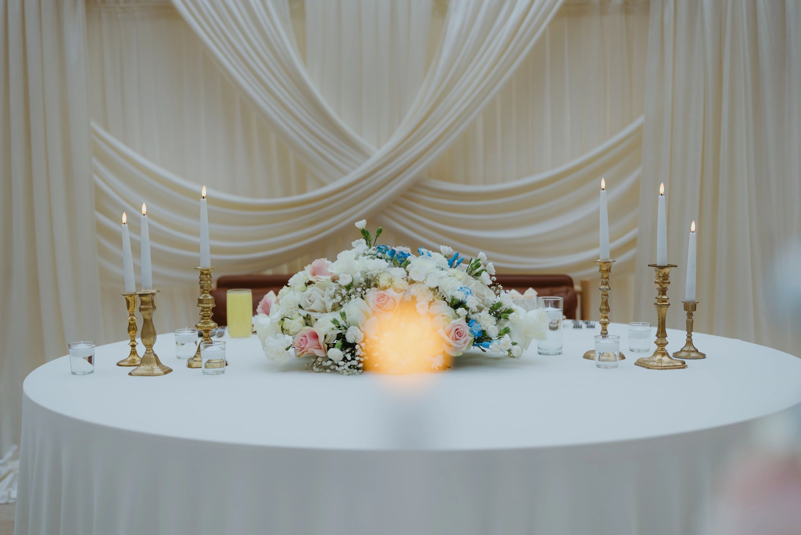Wedding reception table with floral centerpiece and candlelight